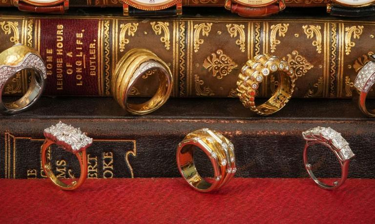 Gold and diamond rings displayed on antique books