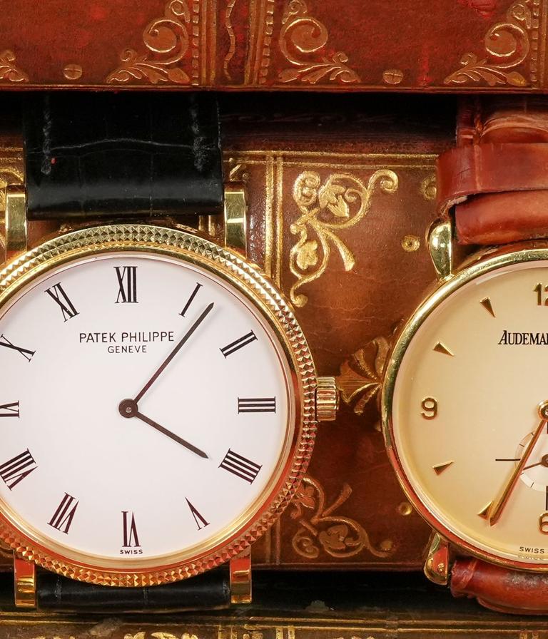 Patek Philippe and Audemars Piguet wristwatches on antique books